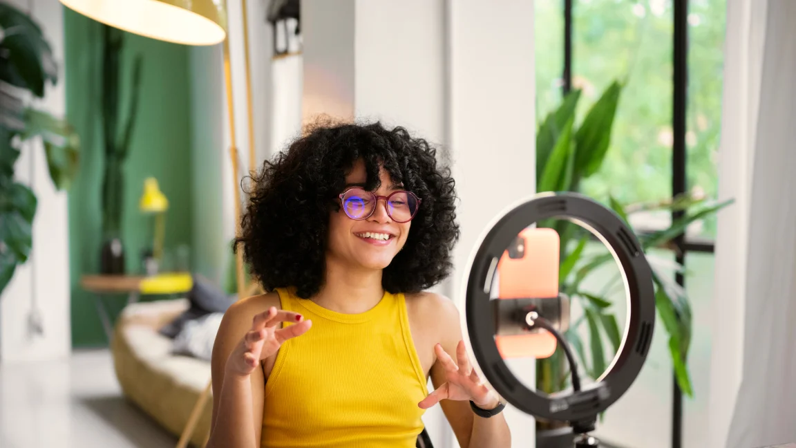 Young man smiling while recording videos for tiktok
