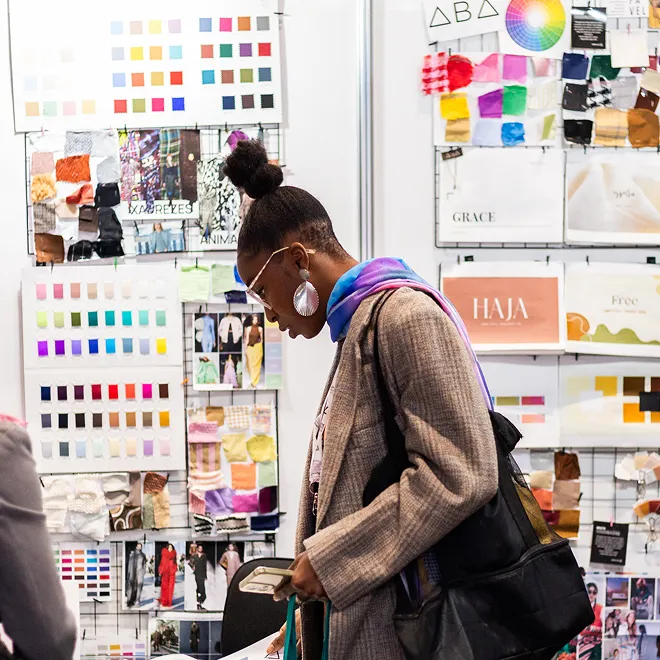 Person analyzing products at a Gotex Show booth